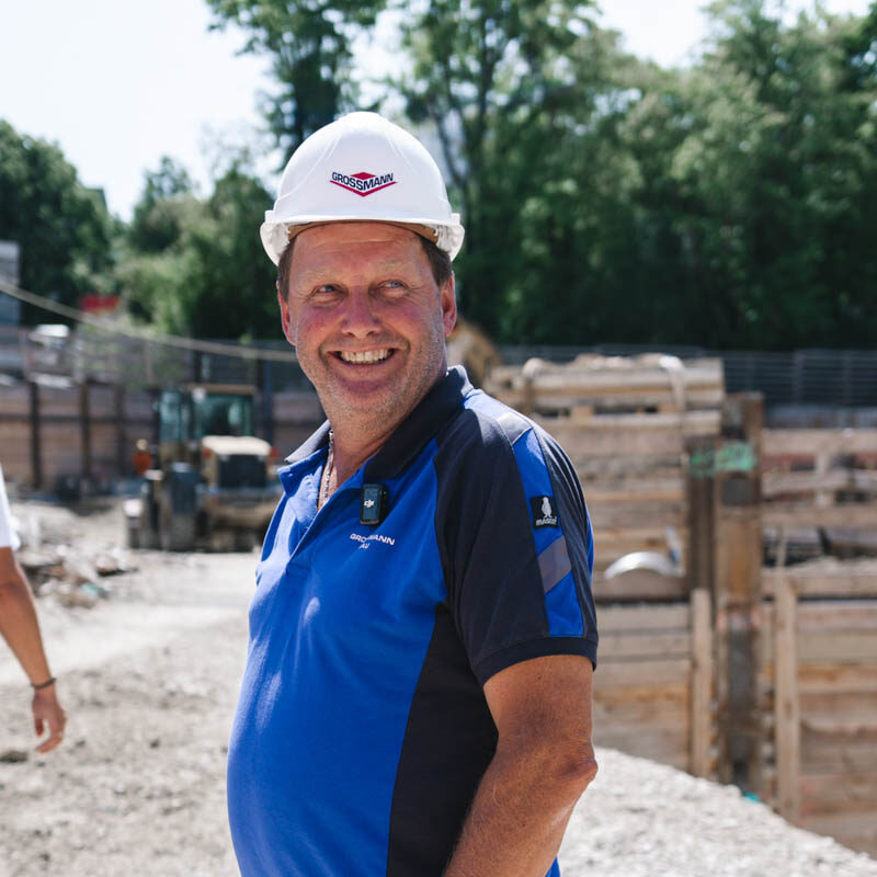 Mitarbeiter von Grossmann steht auf einer sonnigen Baustelle